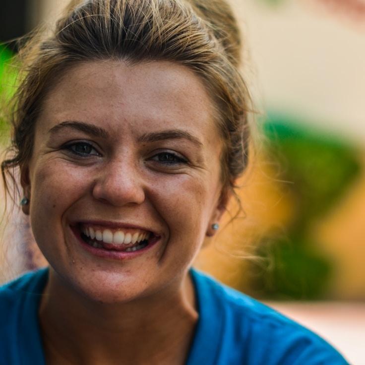 Aisha Rahman, Lead Design Curator at Verdant & Vine, reviewing corporate floral arrangements